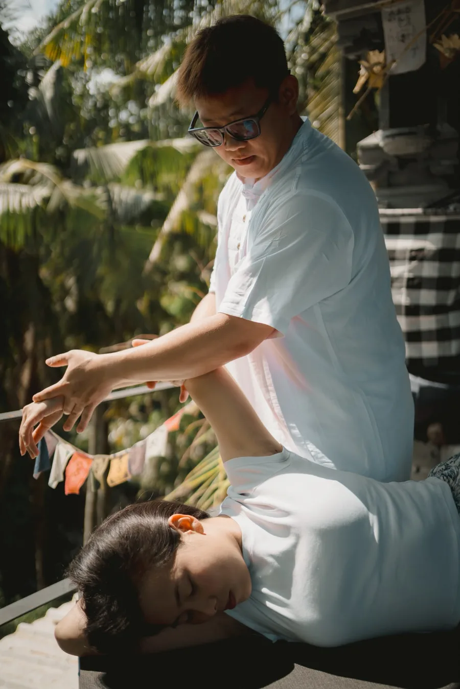 Specialist assisting a client through a stretch at INARA Sanctuary